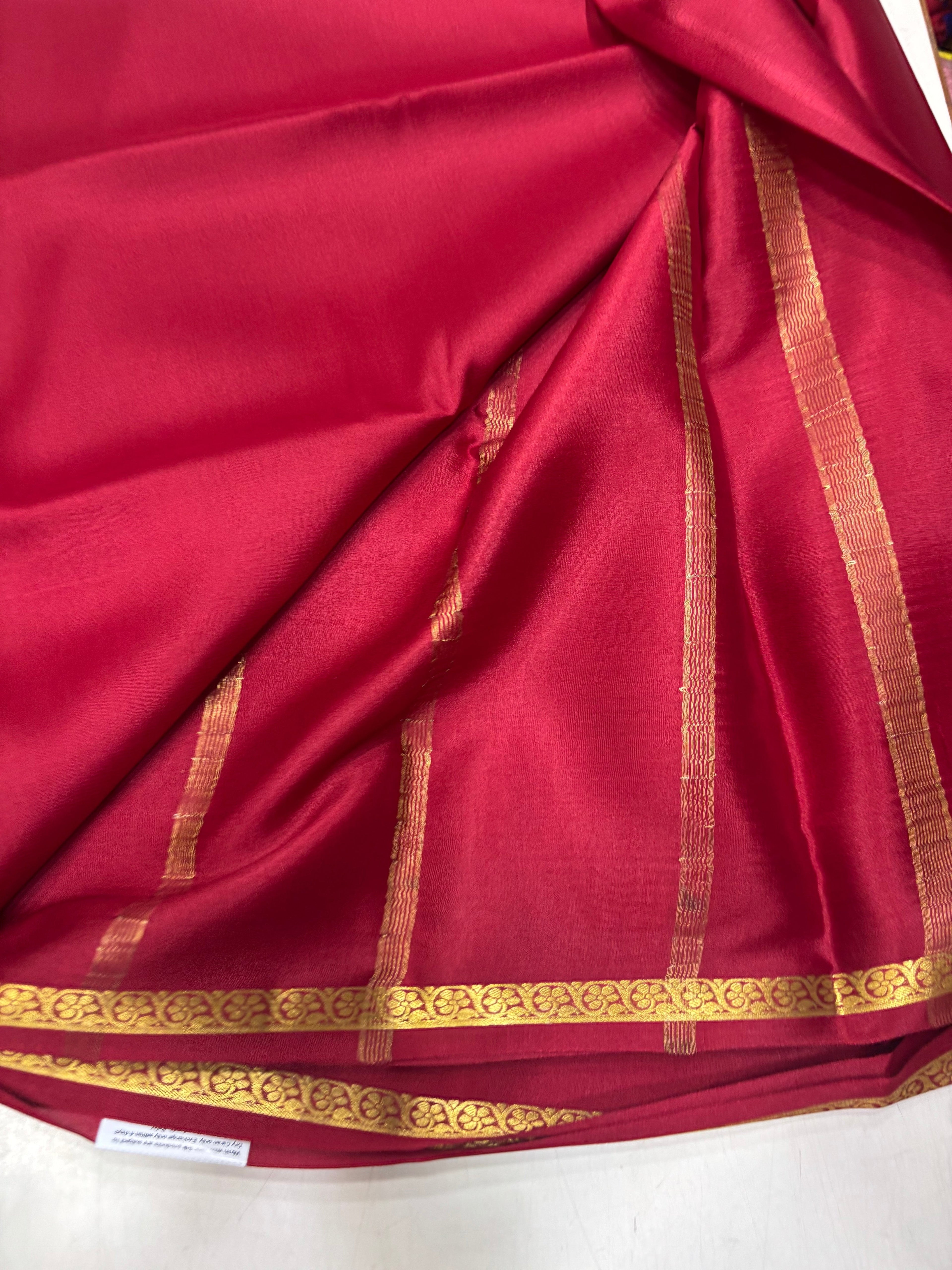 SRI NANDINI SILK red crepe silk saree with gold border and vertical stripes, suitable for festivities.