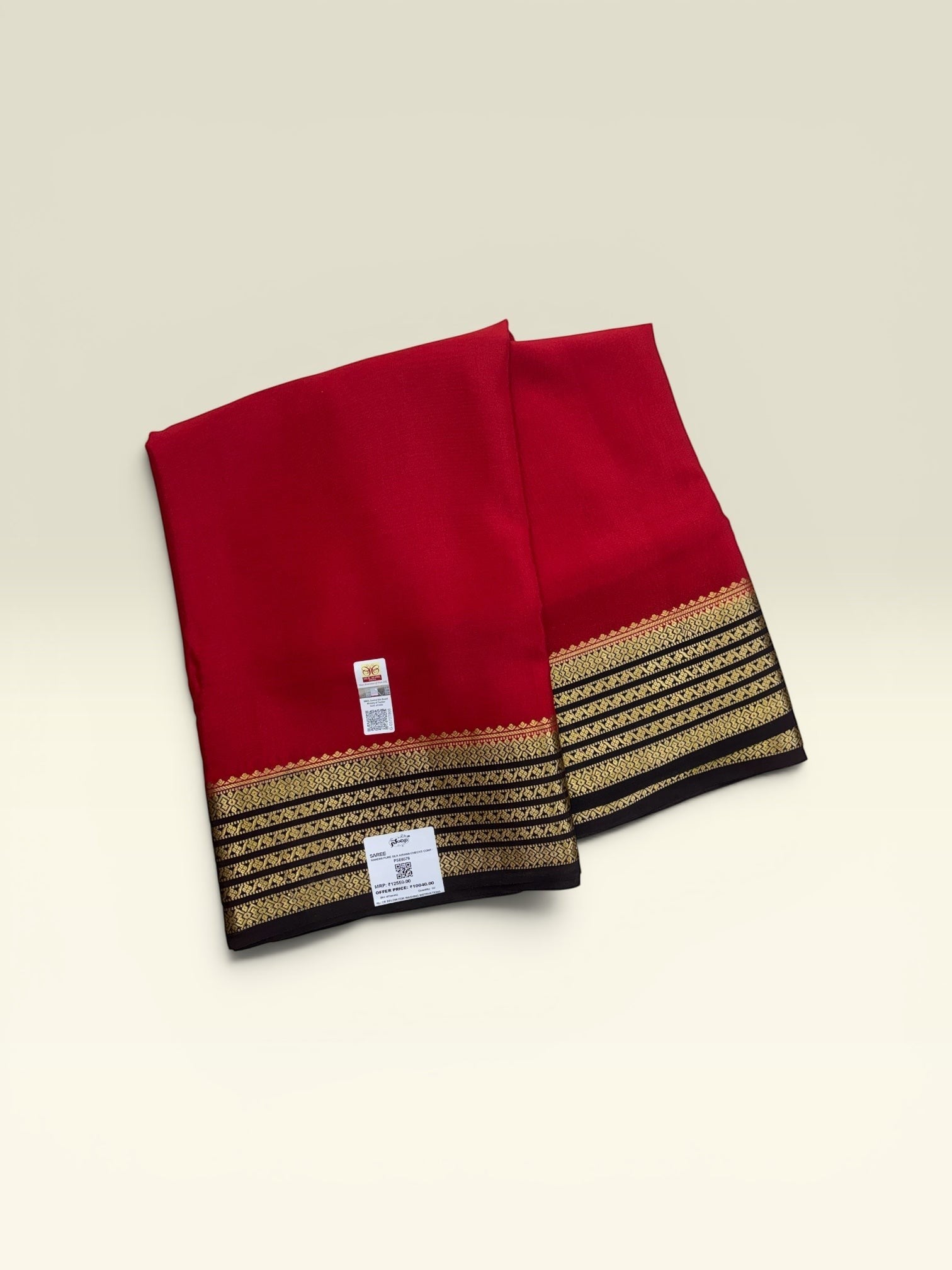 SRI NANDINI SILK Red pure silk saree with black and gold border. Traditional self pattern, ideal for festivities.