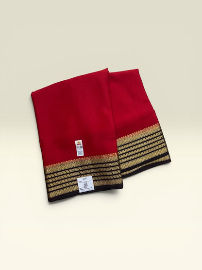 SRI NANDINI SILK Red pure silk saree with black and gold border. Traditional self pattern, ideal for festivities.